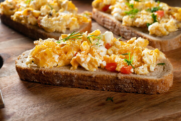 Scrambled eggs on a slice of bread.