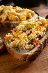 Scrambled eggs on a slice of bread.