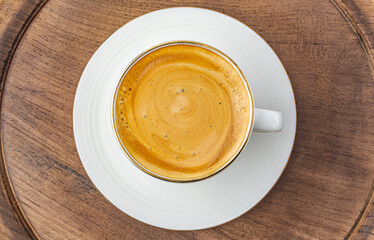 cup of espresso on wooden background top view