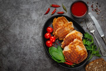 Grilled pork steaks in a pan with spices with copy space