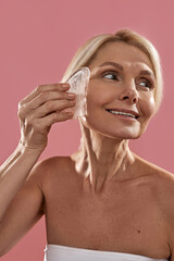 Caucasian woman applying ice slice on her face