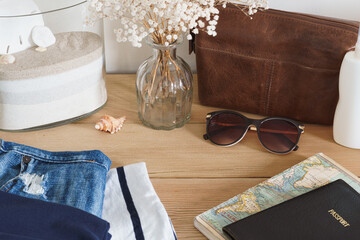 Table top style holiday or vacation concept image. Passport, maps, sunglasses, flip flops and other...