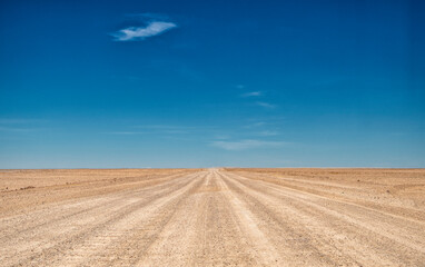 Fototapeta na wymiar endless expanses on a gravel road through the desert, Namibia