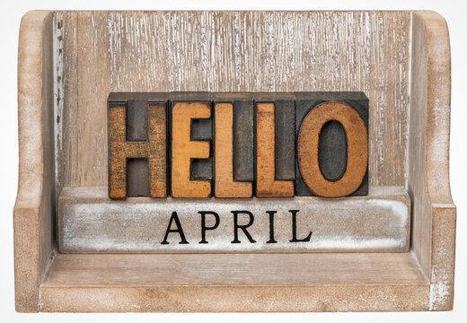 Hello April in vintage letterpress wood type inside grunge wooden box, calendar concept