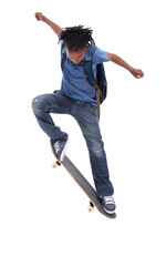 Showing off his mad skills. A young African-American boy doing a trick on his skateboard.