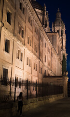 Tourist walking at night through the city of Salamanca
