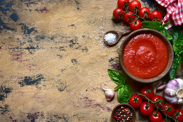 Homemade tomato sauce with ingredients for making. Top view with copy space.