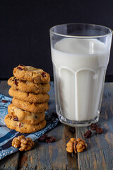 chocolate chip cookies stacked and a glass of milk
