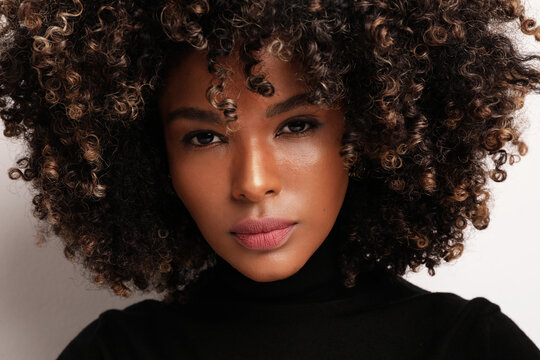 African American beauty. Young woman with curly hair on white background.