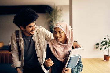 Young happy Muslim couple has fun while going to lecture at the university.
