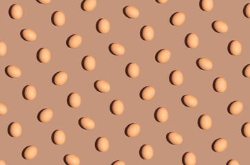 Easter flat lay concept with organic eggs on pastel brown background. Aesthetic creative pattern idea, monochromatic minimal vibe.