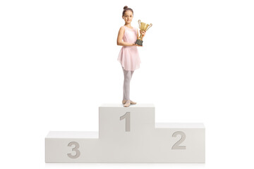 Ballerina in a pink dress holding a gold trophy cup on a winner podium