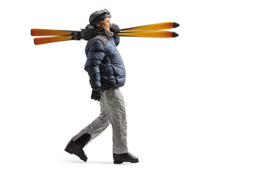 Full length profile shot of a mature man in a skiing equipment