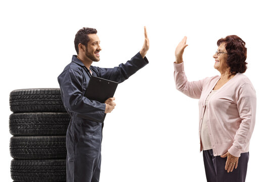 Auto mechanic gesturing high-five with a mature lady