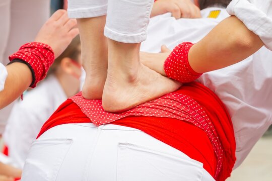 Non-recognizable people called Castellers make a Castell or Human Tower, a typical tradition in the festivities of Catalonia. 