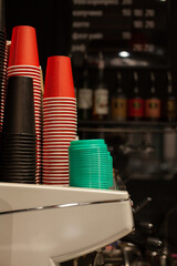 Colored paper cups for coffee on the counter