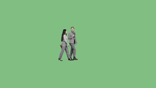 A young man and a woman walk together and talk. Green screen clip with alpha channel