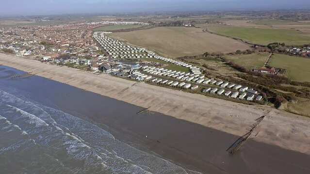 Aerial footage of Bracklesham Bay and the holiday resort caravan park from the coast of the English Channel near East Wittering.