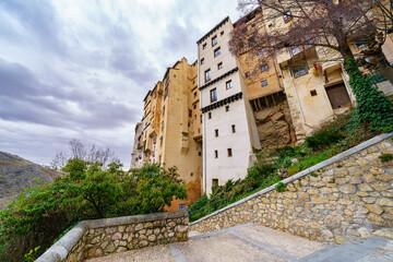 Fototapeta na wymiar Tall buildings with houses built into the rock cliff, Cuenca Spain.