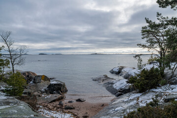 View of the rocky shore of Puistovuori and sea in winter, Hanko, Finland