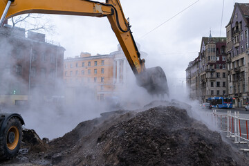 Fototapeta premium Emergency service team of municipal services working on liquidation of hot water pipeline accident or canalization, hot steam from the pit. Elimination of accident of underground utilities in Russia