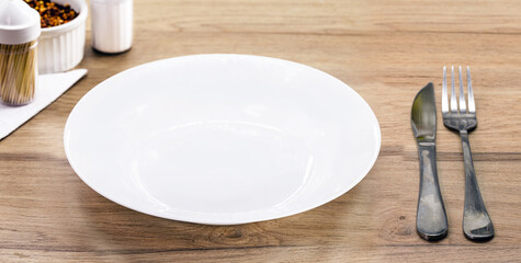 rustic table mockup , top view, empty round and white plate for food, cutlery on the side, vintage backdrop, homemade food concept