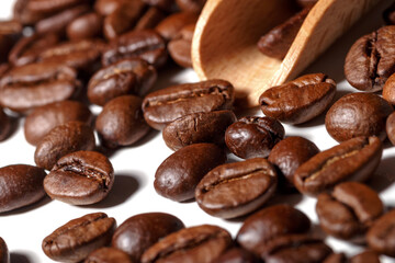 Heap of fresh roasted coffee beans isolated on white background as package design elements