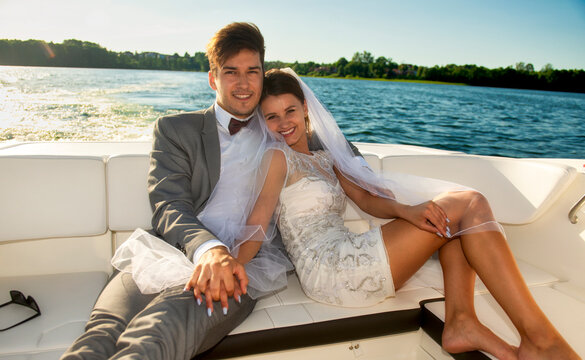 Newlywed. Young couple. Groom and bride. Photo session on a speedboat. Lake