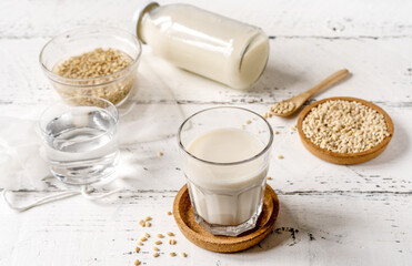 Homemade vegan barley milk in glass with seeds