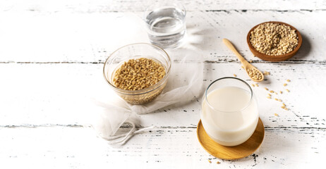 Vegan barley milk in glass with seeds