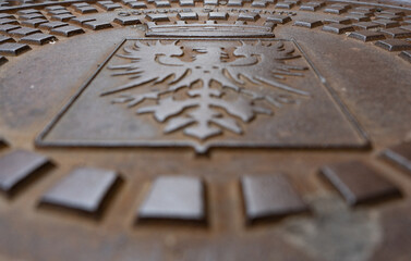 symbol of the eagle in an urban manhole in the city of Trento
