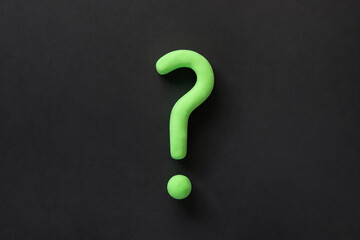 Green question mark on black background. 3d model, mock-up of interrogation point. Asking for...