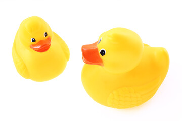Yellow rubber duck bath toys on white background high angle view