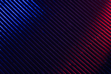 Futuristic background. Ridged texture. Glowing striped structure. Neon blue red color gradient...