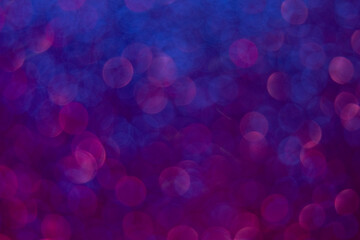 Neon bokeh glow. Blur light background. Night illumination. Defocused blue pink purple color radiance round flecks pattern on dark abstract overlay.