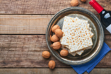 Matzah, red kosher and walnut. Traditional ritual Jewish bread on old wooden rustic background. Passover food. Pesach Jewish holiday of Passover celebration concept.