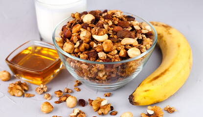 A tasty crispy granola with banana, yogurt and honey for breakfast. Healthy breakfast concept. Сlose-up.