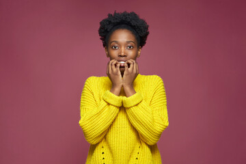 Scared young african american woman frightened terrified by horror movie or domestic violence. Fear emotion