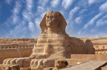Great Sphinx of Giza near Cairo, Egypt. It is mythical creature with the head of man and the body of a lion. The face of the Sphinx appears to represent the pharaoh Khafre - obrazy, fototapety, plakaty