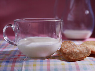 Glass of fresh milk and baked cookies close up shot