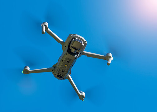 Drone. Professional drone with 4K or 5K camera for take a video, photo, film, movie footage. Aerial photography or videography. Flying on blue sky background. Flight technology. 