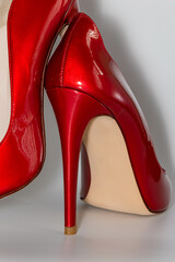 Close up view of the red colored high heeled women's shoes.