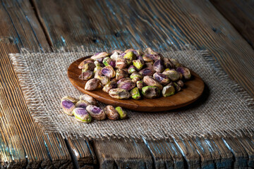 Peeled pistachios on a wooden background. Close-up.