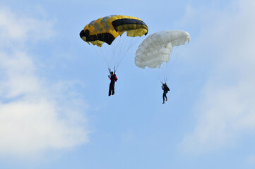 Athletes skydivers in the blue sky