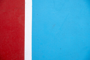 View of a blue and red tennis court. Side line of the tennis court