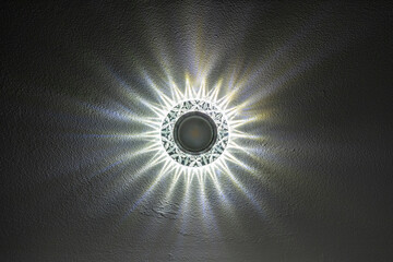 ceiling lamp with faceted edges. Beautiful glow of the lamp