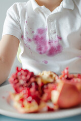 Close up dirty stain of fresh pomegranate on clothes. 