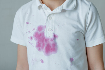 Dirty stain of spilling juice on children's clothes. High quality photo