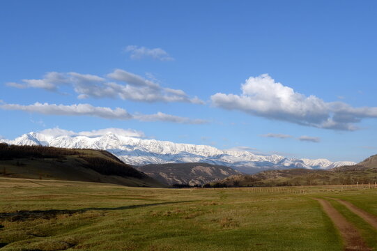 View of the North Chui mountain snow-covered ridge from the Kurai steppe. Gorny Altai, Kosh-Agachsky district, Russia