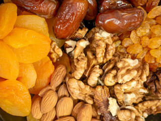 Nuts and dried fruits. Walnuts, almonds, dried apricots, raisins and dates. Healthy food and snacks. Oriental sweets